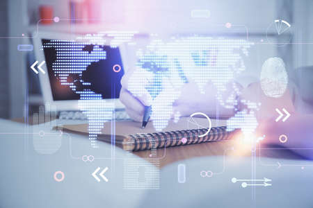 Double exposure of hands making notes with world map hologram and data theme icons. Concept of...