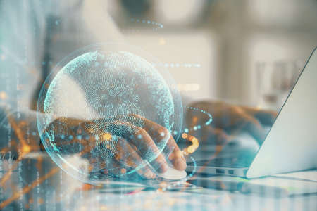 Multi exposure of world map hologram with man working on computer on background. Concept of...
