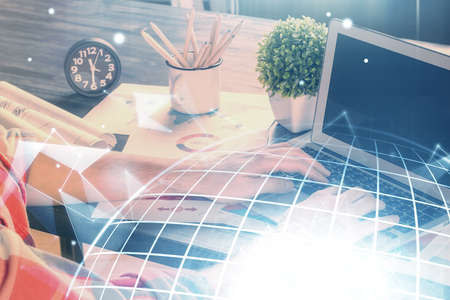 Double exposure of world map hologram with man working on computer on background. Concept of...