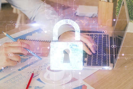 Multi exposure of lock icon with man working on computer on background. Concept of network...