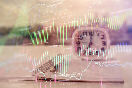 Multi exposure of financial graph drawings and desk with open notebook background. Concept of forexの写真素材