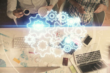 Double exposure of man and woman working together and business theme hologram drawing. Computer background. Top View.の写真素材