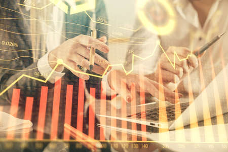 Double exposure of man and woman working together and forex chart hologram. Business concept....