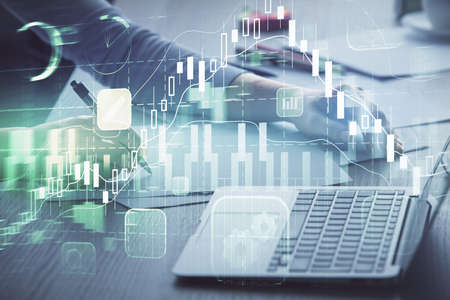 Double exposure of businesswoman hands typing on computer and forex chart hologram drawing....