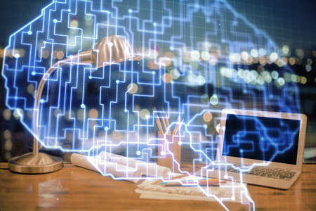 Double exposure of desktop with computer and brain drawing hologram. Artificial intelligence concept.の写真素材