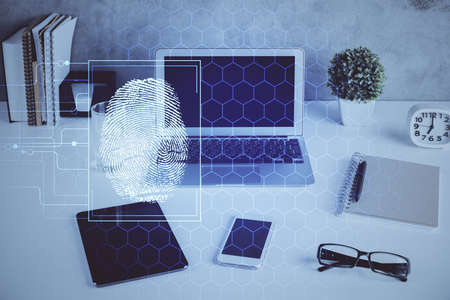 Computer on desktop in office with finger print drawing. Double exposure. Concept of business data...