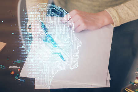Double exposure of writing hand on background with brain hologram. Concept of learning.