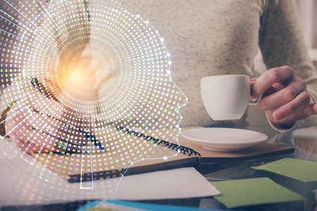 Double exposure of writing hand on background with brain hologram. Concept of learning.
