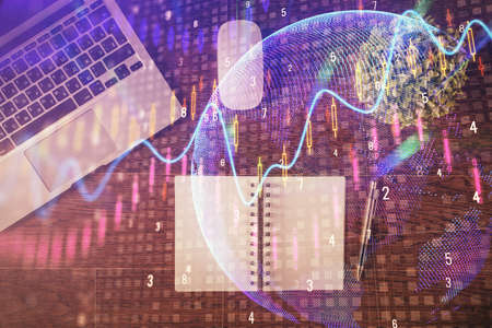 Stock market graph and top view computer on the table background. Double exposure. Concept of...