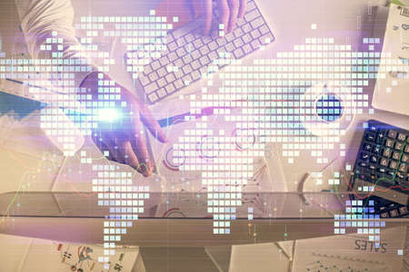 Double exposure of man's hands typing over computer keyboard and business theme hologram drawing....
