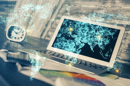 Computer on desktop with social network hologram. Multi exposure. Concept of international people connections.の写真素材