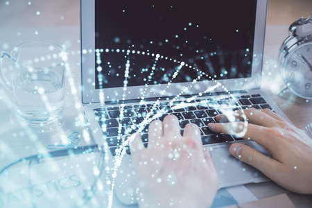 DNA hologram with businessman working on computer on background. Concept of bioengineering. Double exposure.の写真素材