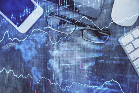 Multi exposure of forex graph hologram over desktop with phone. Top view. Mobile trade platform...