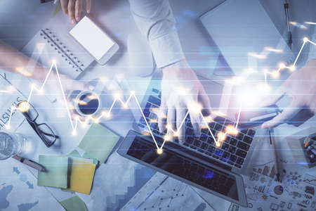Double exposure of man and woman working together and forex graph hologram drawing. Financial...