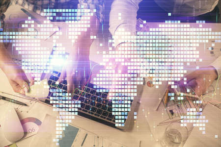 Double exposure of man and woman working together and business theme hologram drawing. Computer background. Top View.の写真素材