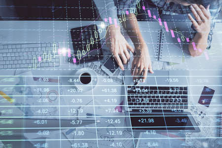 Double exposure of man and woman working together and financial graph hologram drawing. market...