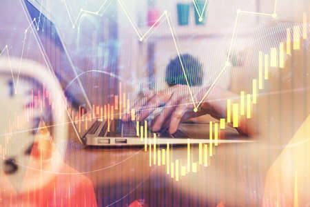 Double exposure of woman hands typing on computer and forex chart hologram drawing. Stock market...