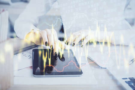 Double exposure of forex chart sketch hologram and woman holding and using a mobile device....