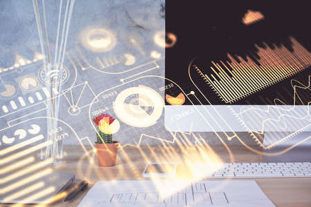 Computer on desktop in office with technology theme hologram. Double exposure. Tech concept.