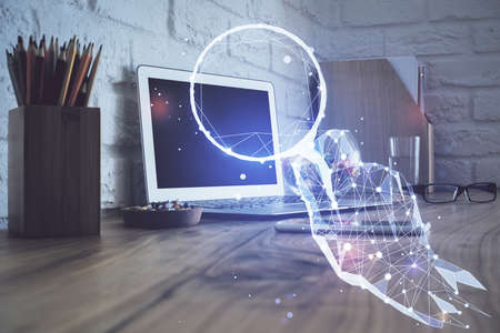 Desktop computer background in office and start up theme hologram drawing. Double exposure. Startup...