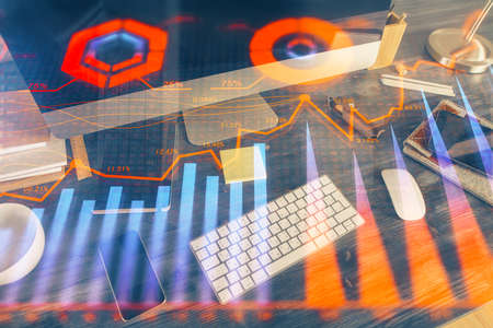 Double exposure of forex graph and work space with computer. Concept of international online...