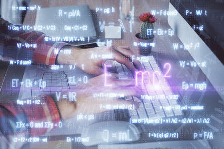 Science formula hologram with man working on computer on background. Education concept. Double...