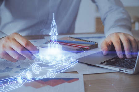 Start up drawings with businessman working on computer on background. Teamwork concept. Double...