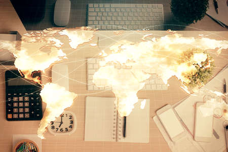 Business theme hologram drawings over computer on the desktop background. Top view. Multi exposure....