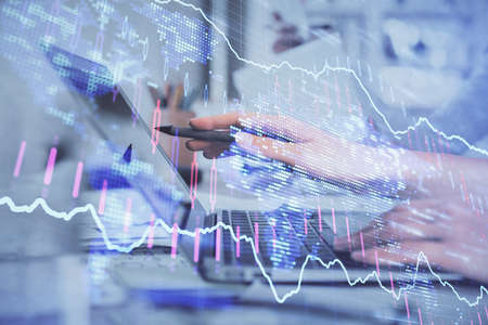 Multi exposure of woman hands typing on computer and financial graph hologram drawing. Stock market...