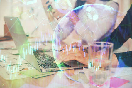 Multi exposure of woman hands typing on computer and forex chart hologram drawing. Stock market...
