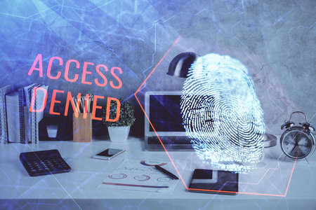 Computer on desktop in office with finger print drawing. Double exposure. Concept of business data security.の写真素材