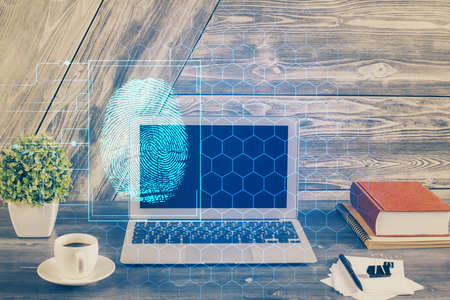 Computer on desktop in office with finger print drawing. Double exposure. Concept of business data...