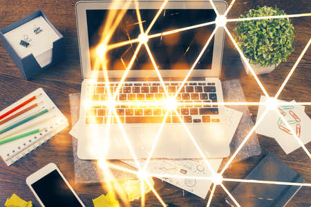Computer on desktop with social network hologram. Multi exposure. Concept of international people connections.の写真素材