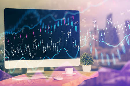Forex market graph hologram and personal computer on background. Multi exposure. Concept of...