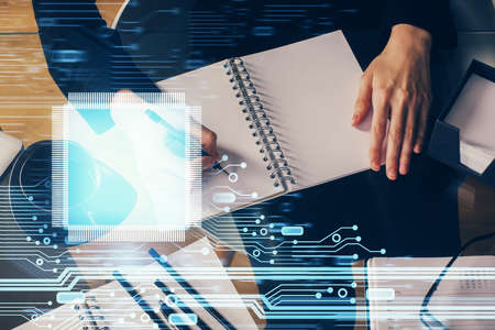 Double exposure of writing hands on background with data solution hologram on front. Technology...