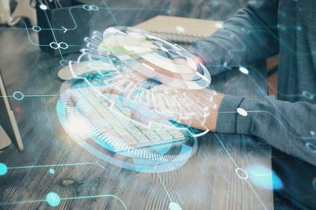 Double exposure of technology hologram with man working on computer background. Concept of big data.