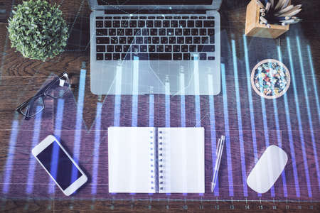 Stock market graph and top view computer on the table background. Double exposure. Concept of financial education.の写真素材