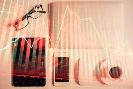Multi exposure of financial chart hologram over desktop with phone. Top view. Mobile trade platform concept.の写真素材