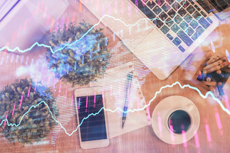Multi exposure of financial chart hologram over desktop with phone. Top view. Mobile trade platform...