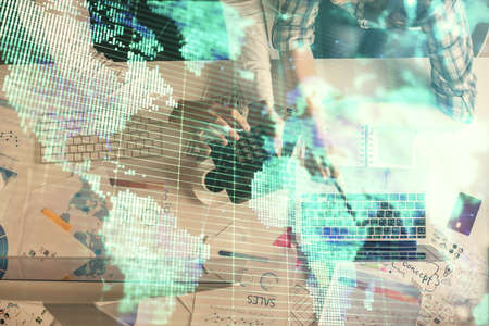 Double exposure of man and woman working together and business theme hologram drawing. Computer...