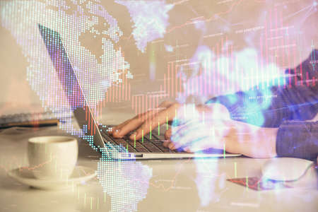 Double exposure of businesswoman hands typing on computer and forex graph hologram drawing....