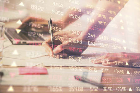 Multi exposure of woman hands typing on computer and financial chart hologram drawing. Stock market...