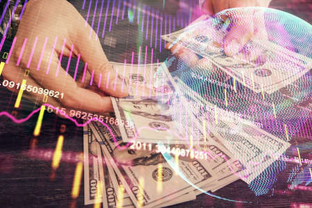 Multi exposure of financial graph drawing hologram and USA dollars bills and man hands. Analysis concept.の写真素材