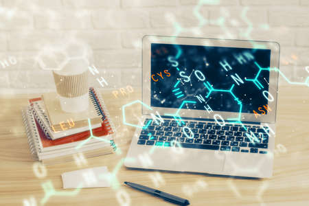 Desktop computer background and formula hologram writing. Double exposure. Education concept.の写真素材