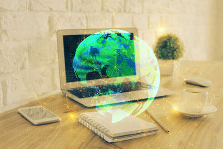 Computer on desktop with social network hologram. Multi exposure. Concept of international people...