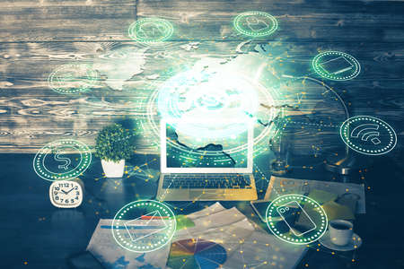 Computer on desktop with social network hologram. Multi exposure. Concept of international people...