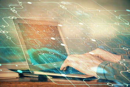 A man working on Laptop with technology theme drawing. Concept of big data. Double exposure.