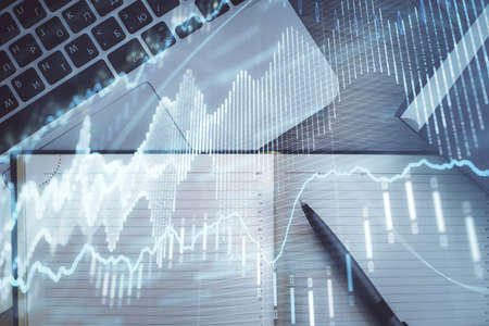 Stock market graph and top view computer on the table background. Multi exposure. Concept of...