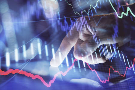 Multi exposure of mans hands holding and using a phone and financial chart drawing. Market analysis...