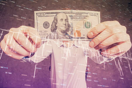 Multi exposure of forex graph drawing hologram and USA dollars bills and man hands. Technical Analysis concept.の写真素材